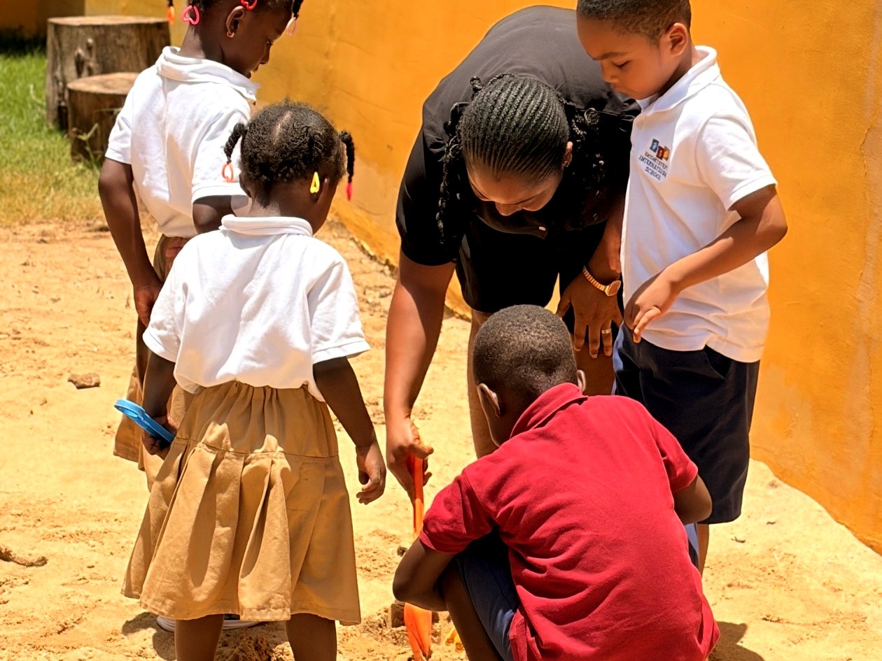 A BrightSteps teacher exploring with students outdoors