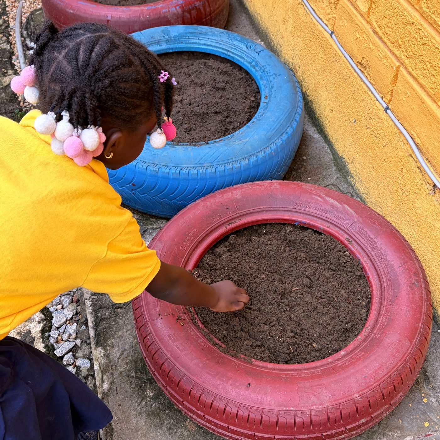 A BrightSteps student planting in the school garden